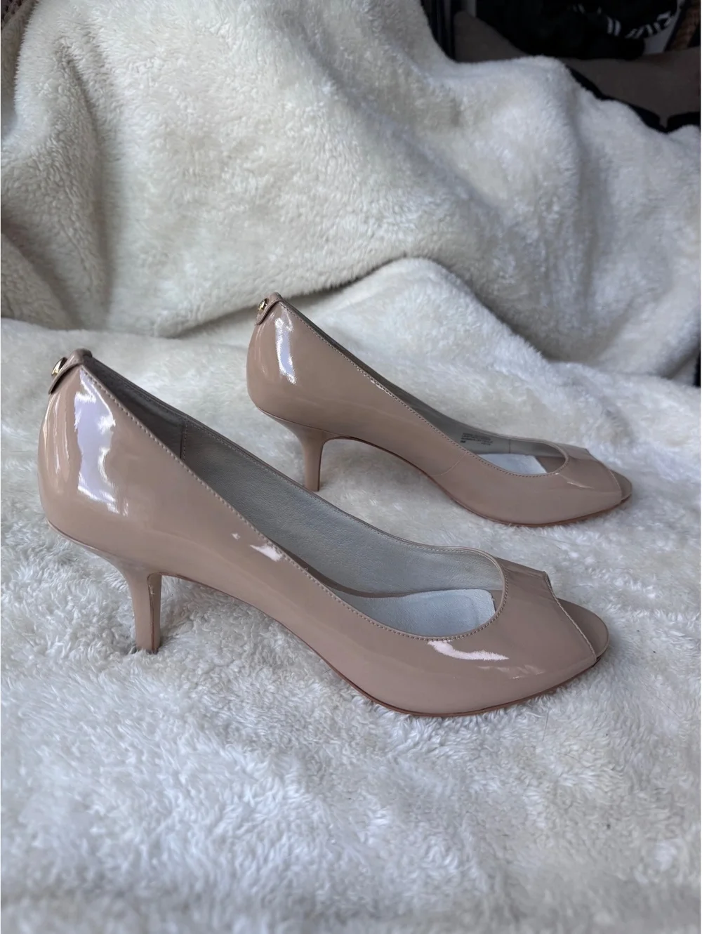 Michael Kors women’s patent leather peep-toe pumps in a classic nude/blush color